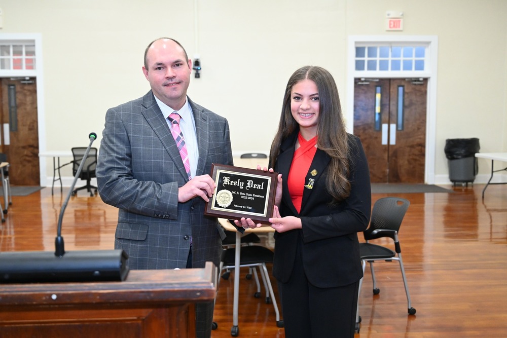 Drew Davis, Director of Curriculum and Instruction at PSRC, left stands recently with 2023-2024 North Carolina Junior Beta State President-Elect Keely Deal during a plaque presentation