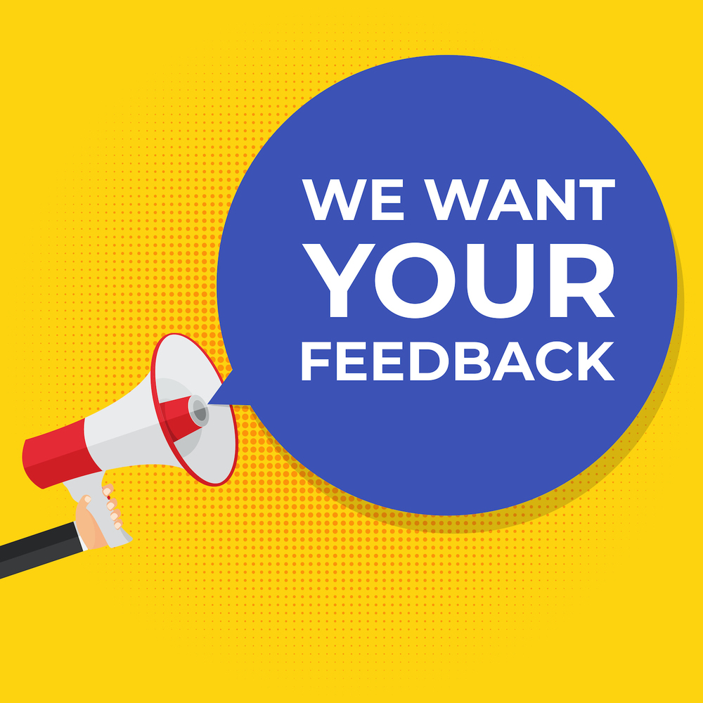 We want your feedback - hand with megaphone