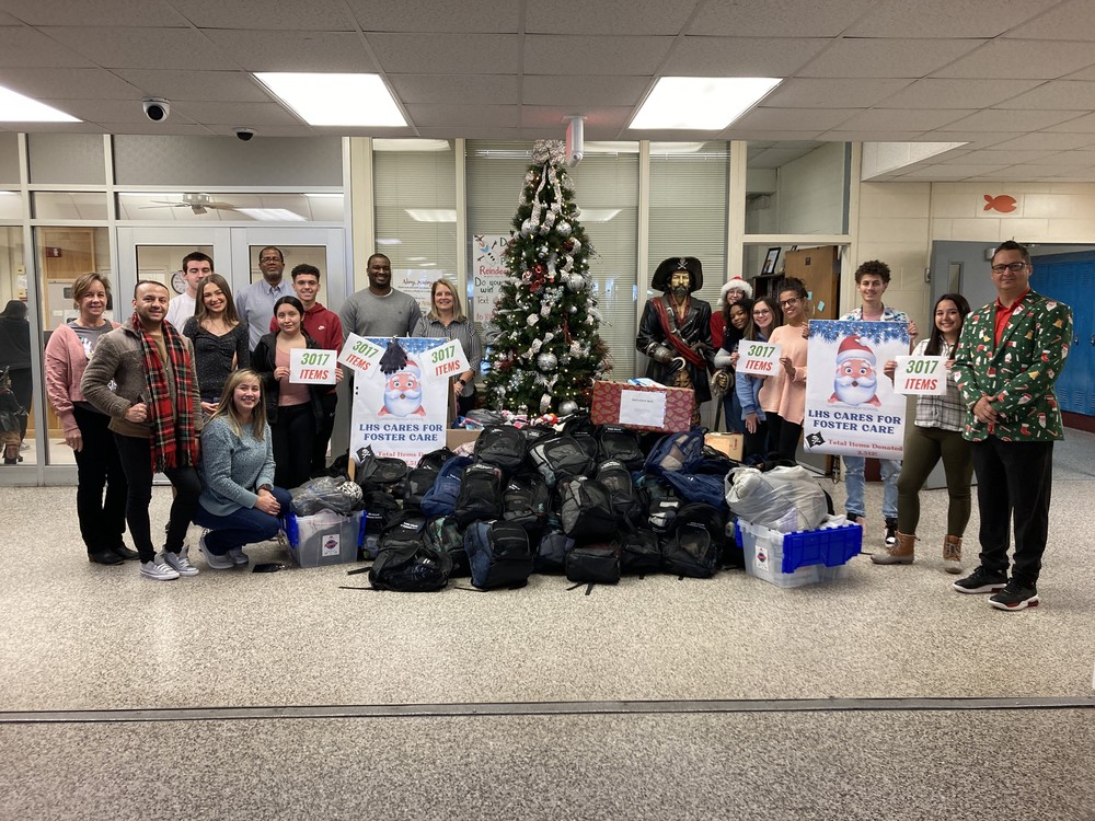 Lumberton High School students, staff and Robeson County DSS officials stand Tuesday with donations  for foster care children and families